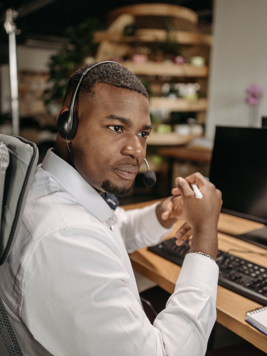 A dispatcher with a headset works at his desk