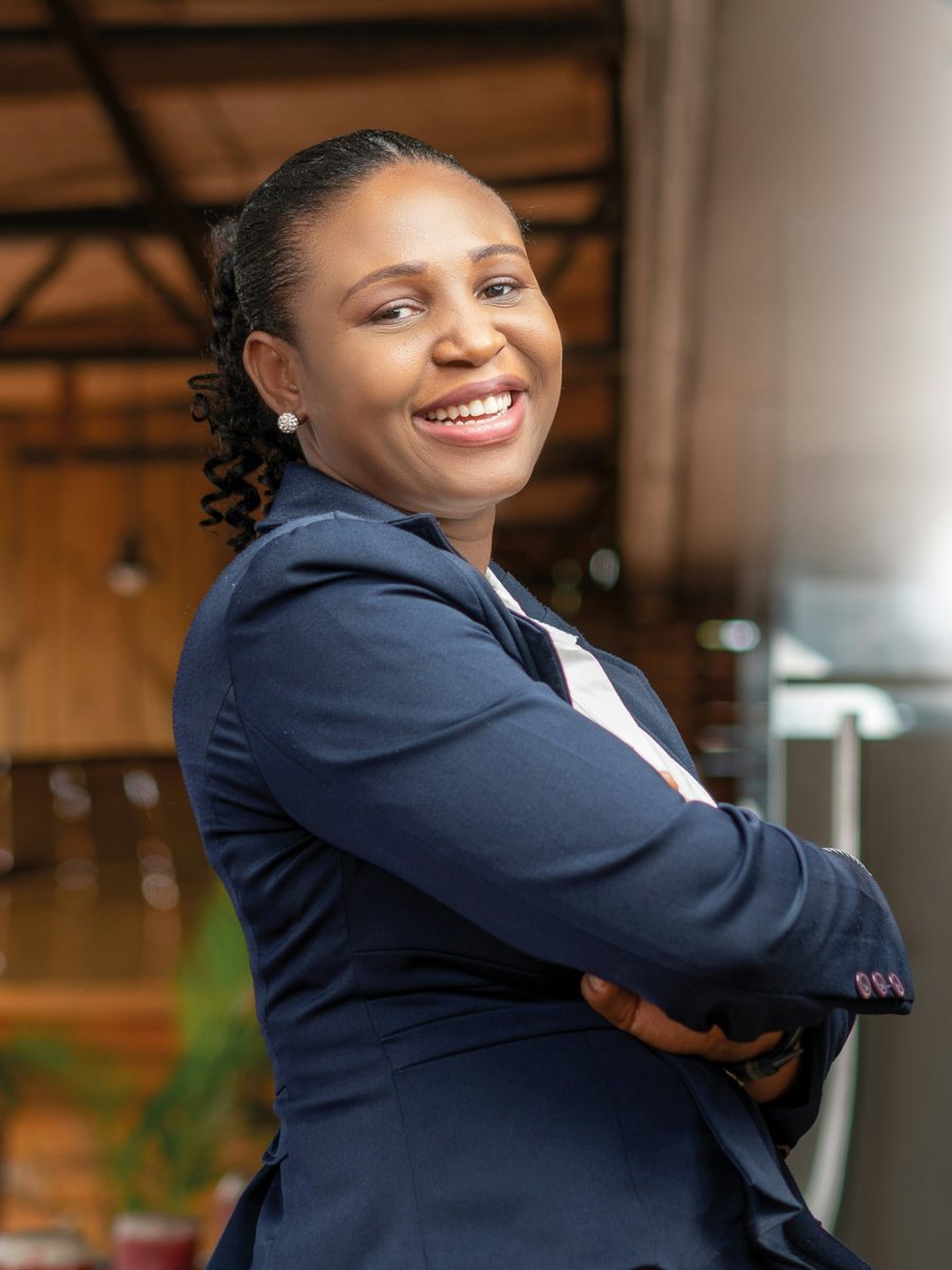 A smiling loan officer in a navy blazer at her branch